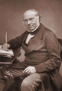 a man sitting at a desk writing on a paper