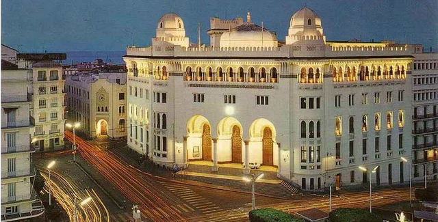 a large white building with arched windows - post office HQ