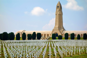 a large cemetery with a tower and many white crosses